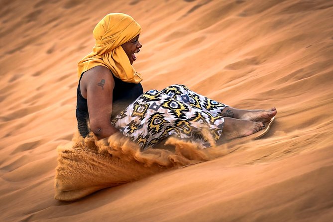 Doha Desert Safari: Dunebashing, Camel, Sandboarding & Inland Sea - Sandboarding down the soft slopes