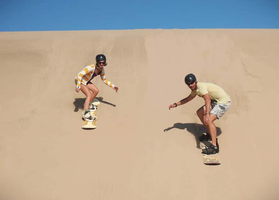 Doha Desert Safari: Sandboarding, Camel Ride & Swimming Fun - Sandboarding Down the Dunes