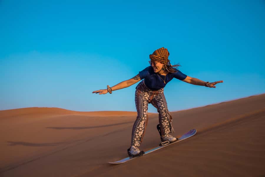 Doha: Half-Day Desert Safari, Quad Bike, Camels & Inland Sea - Sandboarding is simple, fun, and more work than it looks