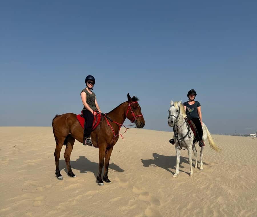 Doha Horseback Riding Adventure in Desert with Transfers - Riding across the sand with an Arabian horse