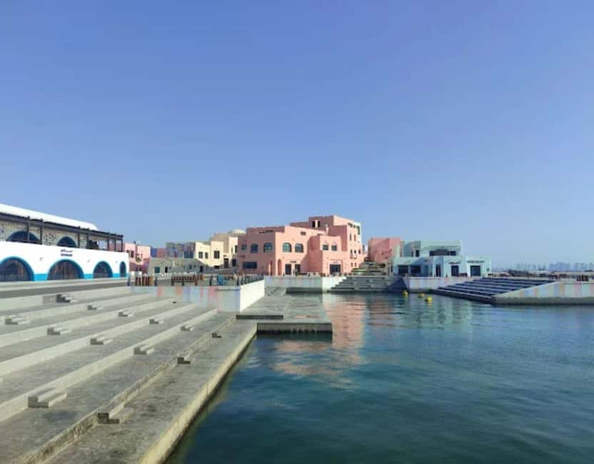 Doha: Mina District's Colorful Streets & Coastal Vibes Tour - The ride to the port and the first walk