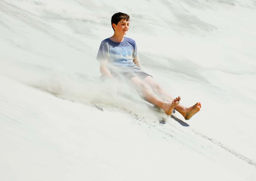 Dune Bashing, Sandboarding, Camel Ride & Optional ATV Ride - Sandboarding on Qatar’s tall dunes