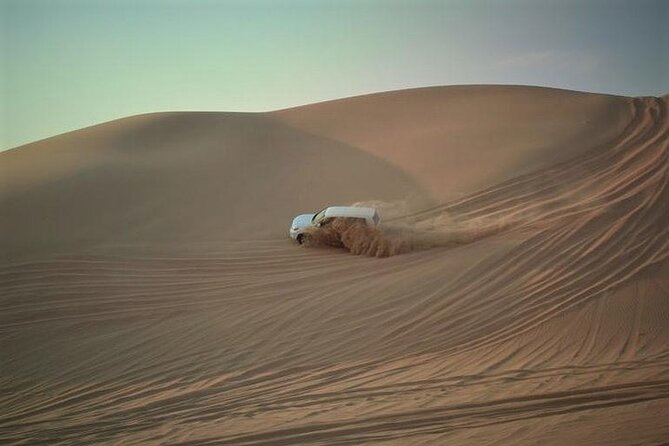 Qatar Sunset Desert Safari: Dune Bashing & Golden Sands Adventure - Sandboarding adds a simple second thrill